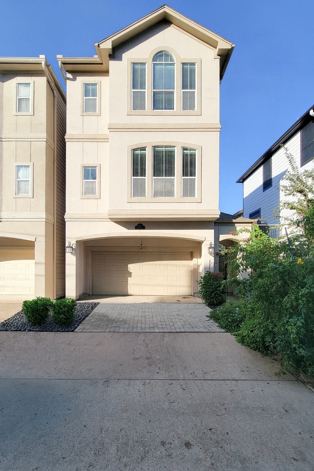 a front view of a house with yard and parking