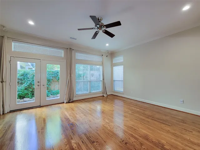 wooden floor in an empty room with a window