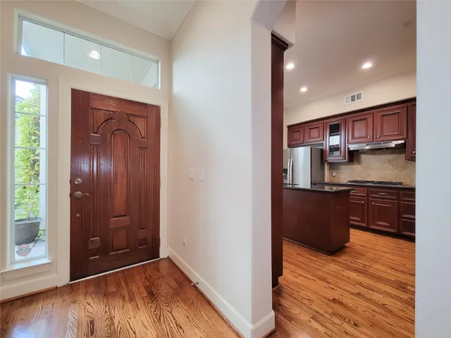 a view of a room with wooden floor and white walls