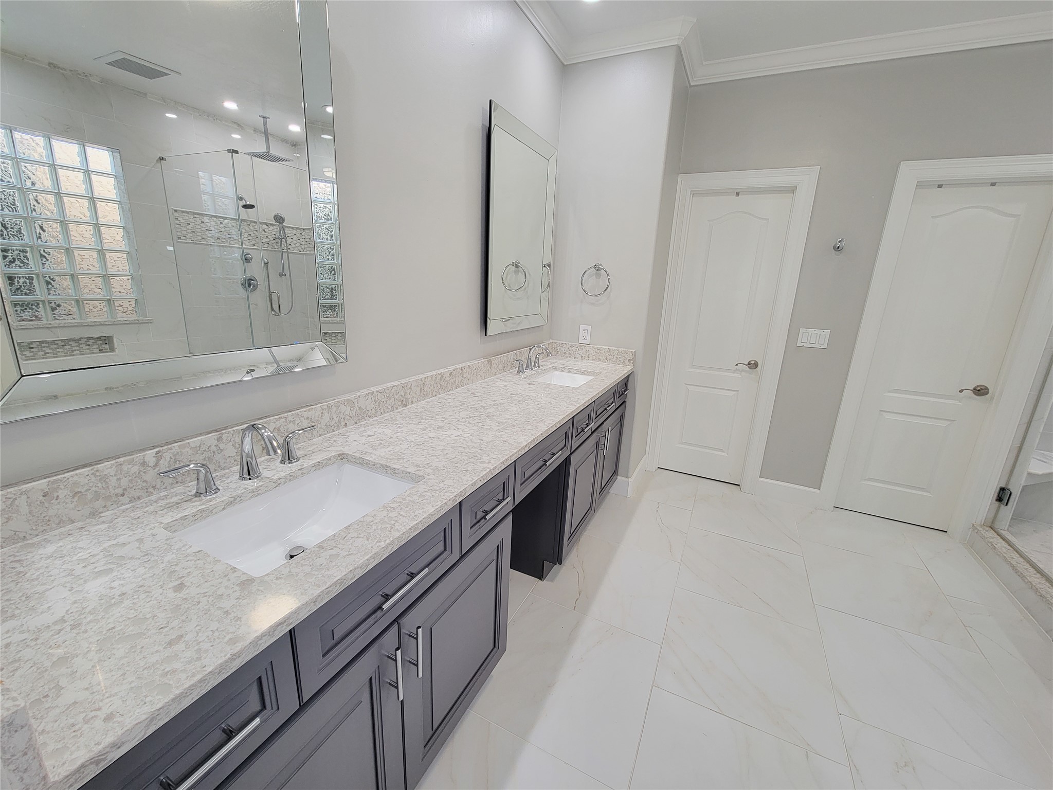 5514 Feagan Street Houston, TX 77007 - Photo 33 of 48 a spacious bathroom with a granite countertop double vanity sink a mirror and a shower