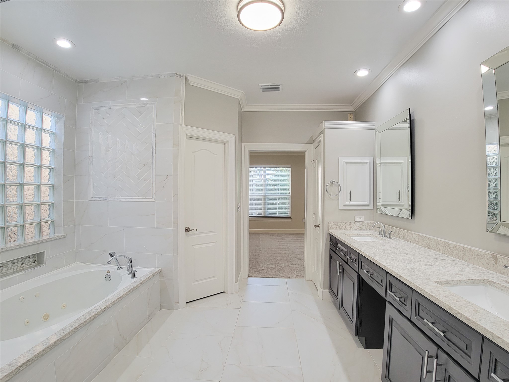 5514 Feagan Street Houston, TX 77007 - Photo 36 of 48 a spacious bathroom with a granite countertop tub sink shower and mirror