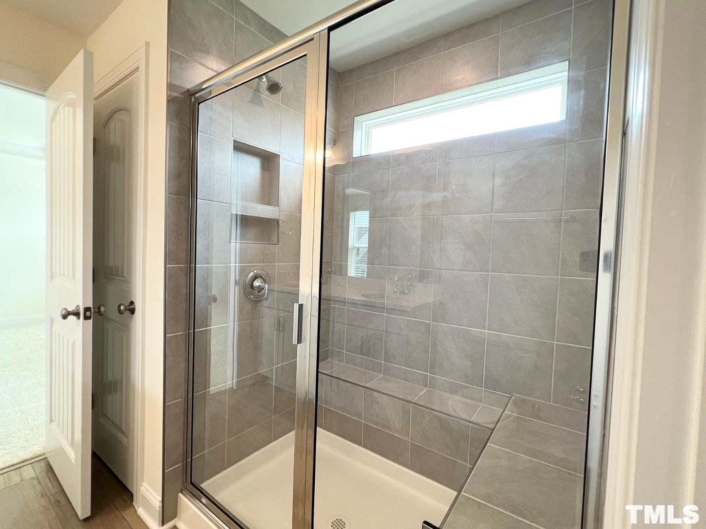 324 Highview Drive Benson, NC 27504 - Photo 8 of 12 a bathroom with a glass shower door