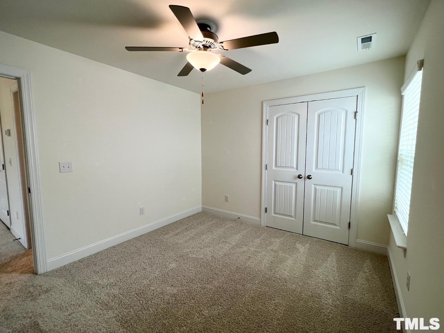 324 Highview Drive Benson, NC 27504 - Photo 10 of 12 an empty room with closet and a ceiling fan
