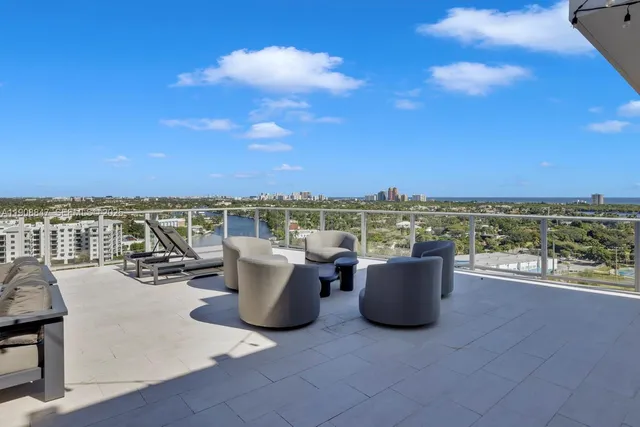 a view of a chairs and table in the balcony