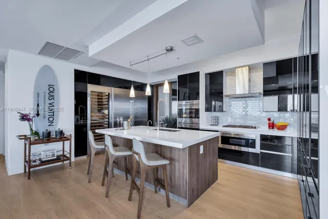 a view of a hallway with white walls and stairs