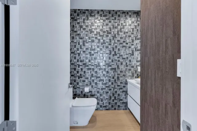 a bathroom with a glass shower door and a sink
