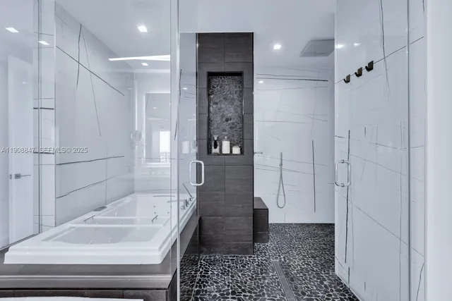 a bathroom with a granite countertop sink a toilet a mirror and shower