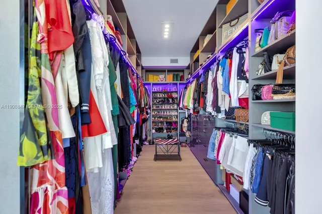 a living room with furniture large windows and a table