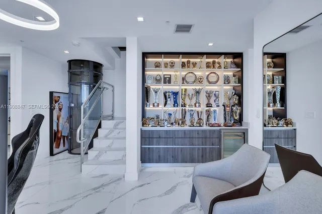 a bedroom with a bed couch and large window