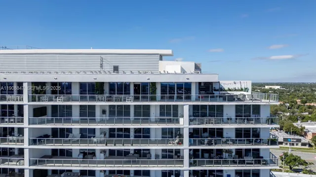 a view of a roof deck with furniture and city view
