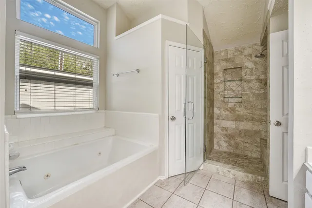 a bathroom with a bathtub and shower