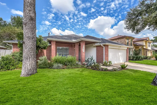 a front view of house with yard and green space