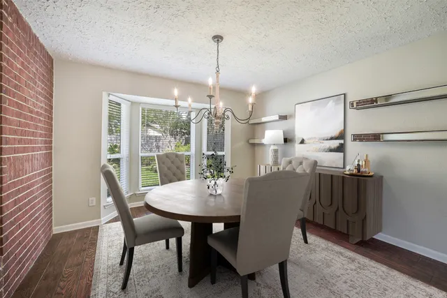 a dining room with furniture window and wooden floor
