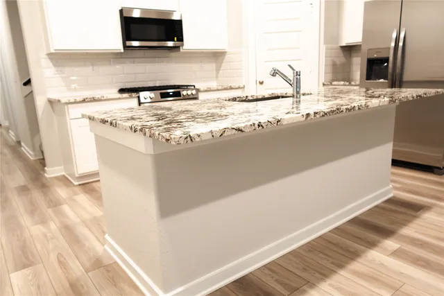 a bathroom with a sink a toilet and bathtub