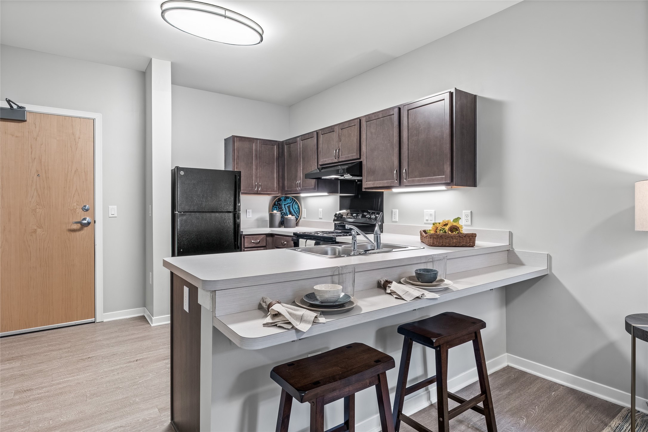 1009 East Dublin Granville Road, Unit 50 Columbus, OH 43229 - Photo 3 of 14 a kitchen with stainless steel appliances a dining table and chairs