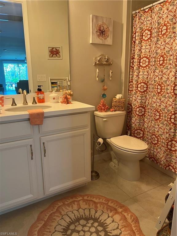 14687 Edgewater Circle Naples, FL 34114 - Photo 28 of 28 a bathroom with a toilet a sink and a mirror
