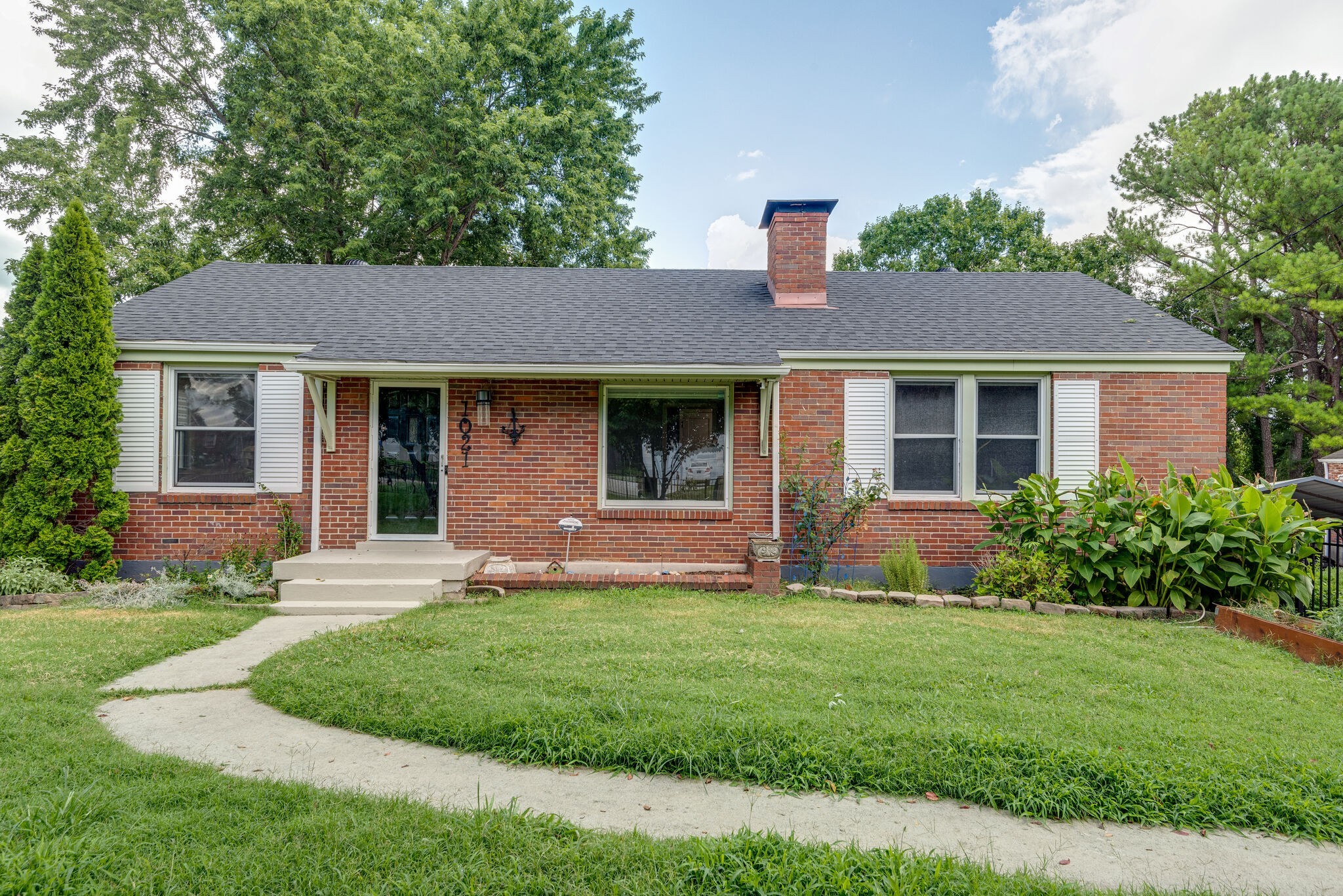 1021 Mitchell Road Nashville, TN 37206 - Photo 4 of 29 a front view of a house with a yard and garage