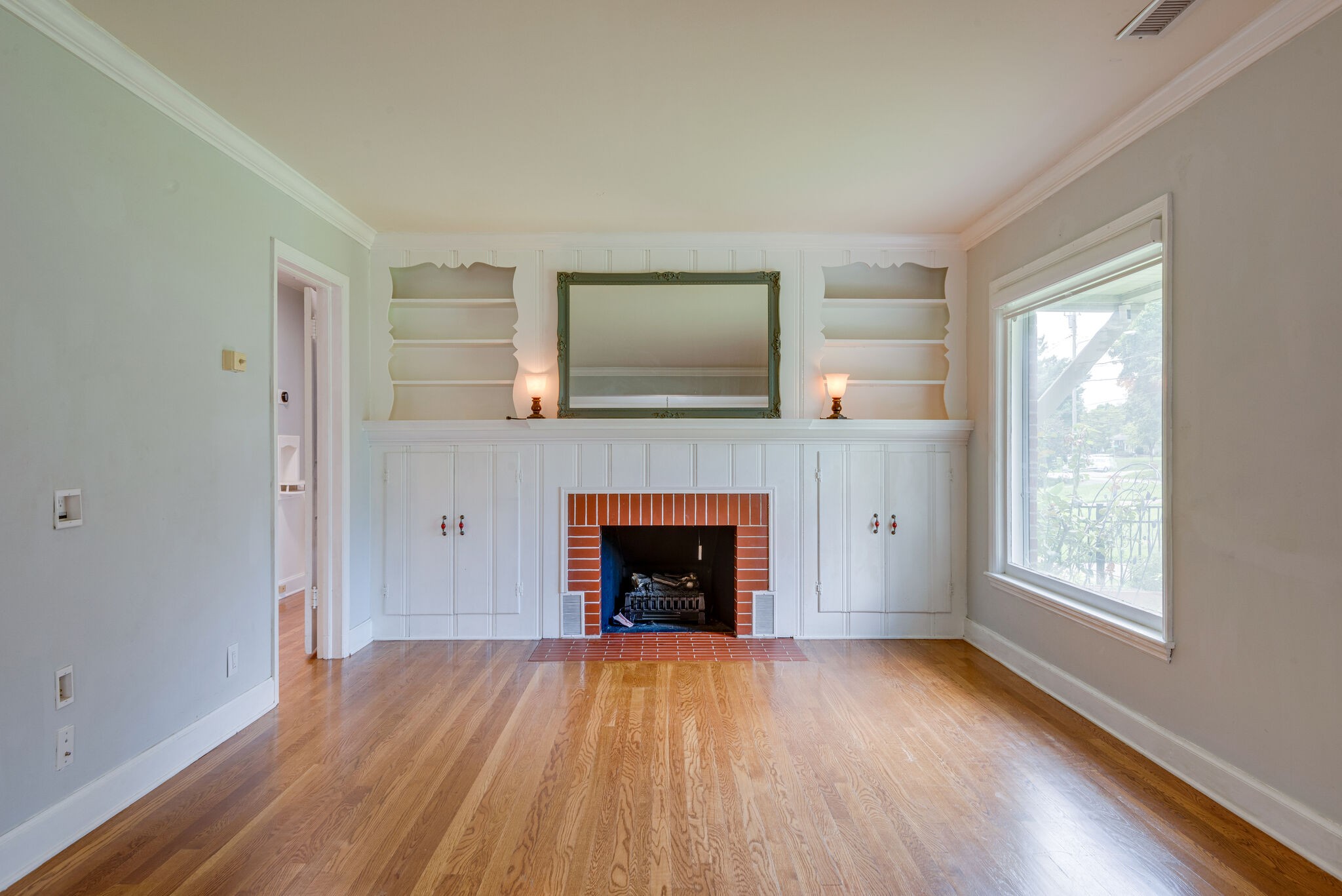 1021 Mitchell Road Nashville, TN 37206 - Photo 6 of 29 a view of an empty room with wooden floor and a window