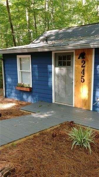 245 Hilton Way Canton, GA 30114 - Photo 2 of 13 a front view of a house with a yard