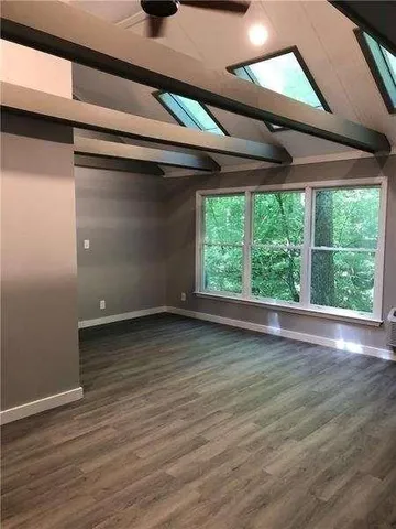 a view of a livingroom with wooden floor and window