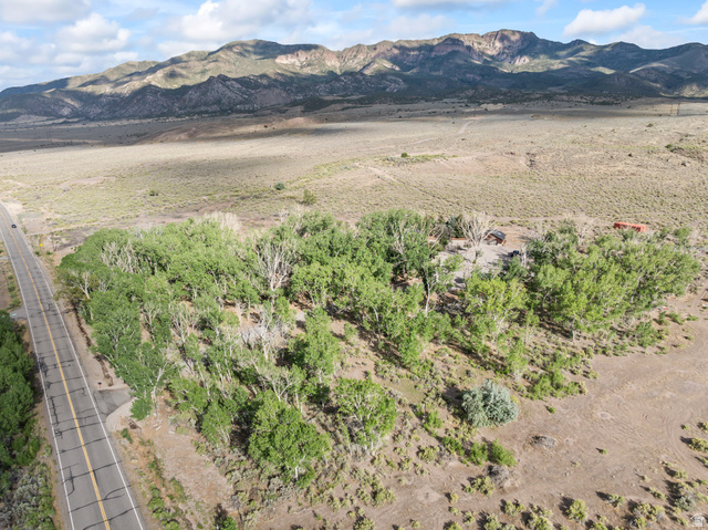 460 Omni Point Road Central Valley, UT 84754 - Photo 89 of 101 Expansive rural land featuring abundant mature trees, direct paved road frontage, and distant mountain ranges