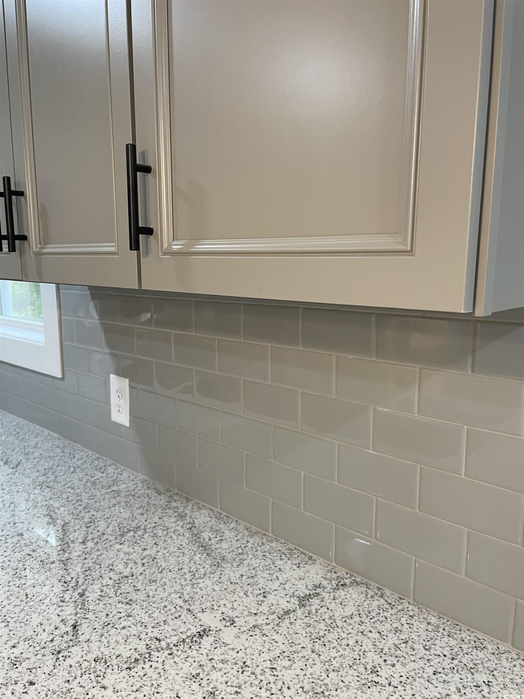 1712 Singleton Street Conway, SC 29527 - Photo 34 of 40 Kitchen view of light stone countertops, decorative backsplash, and white cabinets