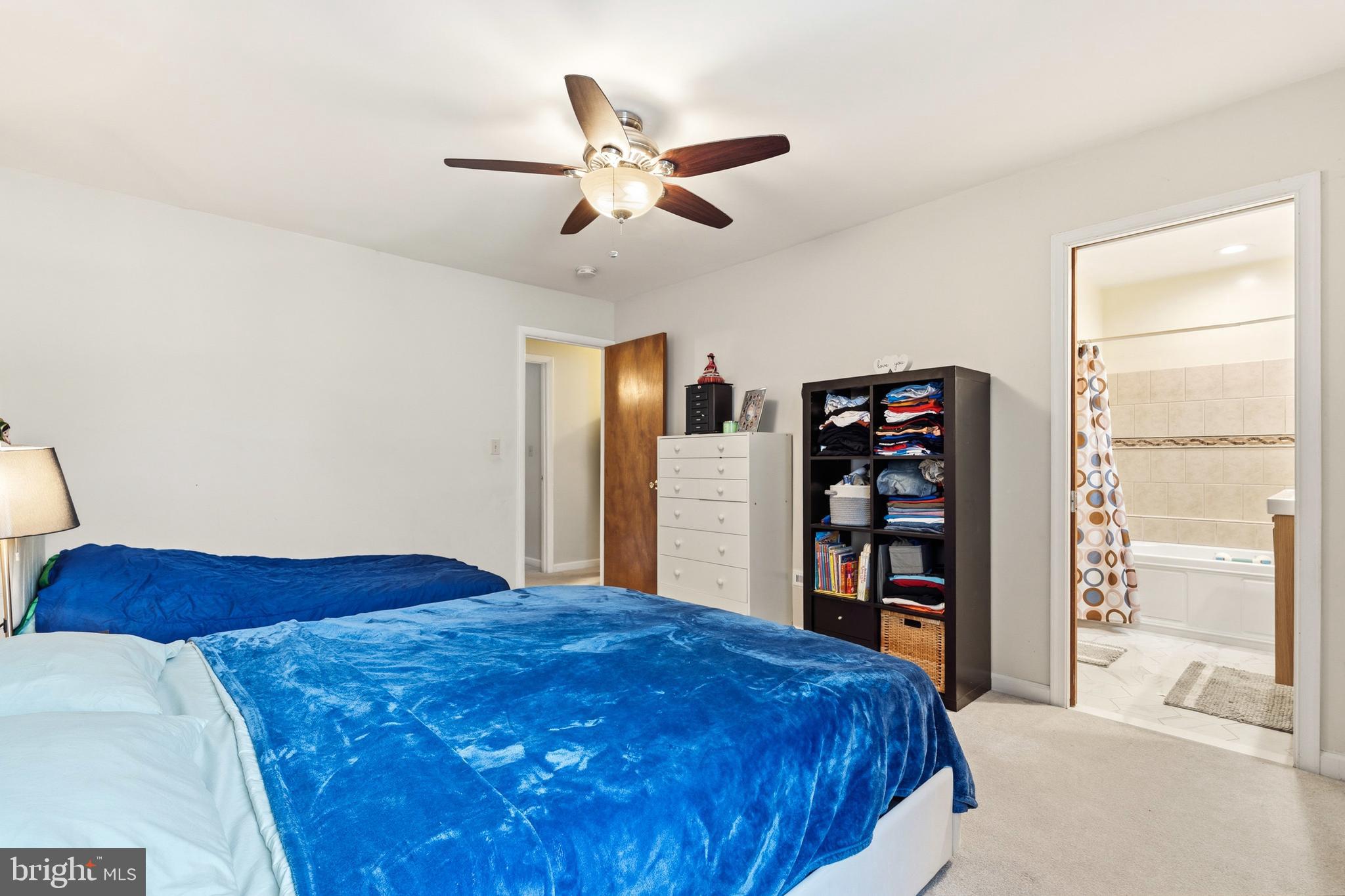 7641 Laytonia Drive Gaithersburg, MD 20877 - Photo 21 of 31 a bedroom with a large bed and a book shelf