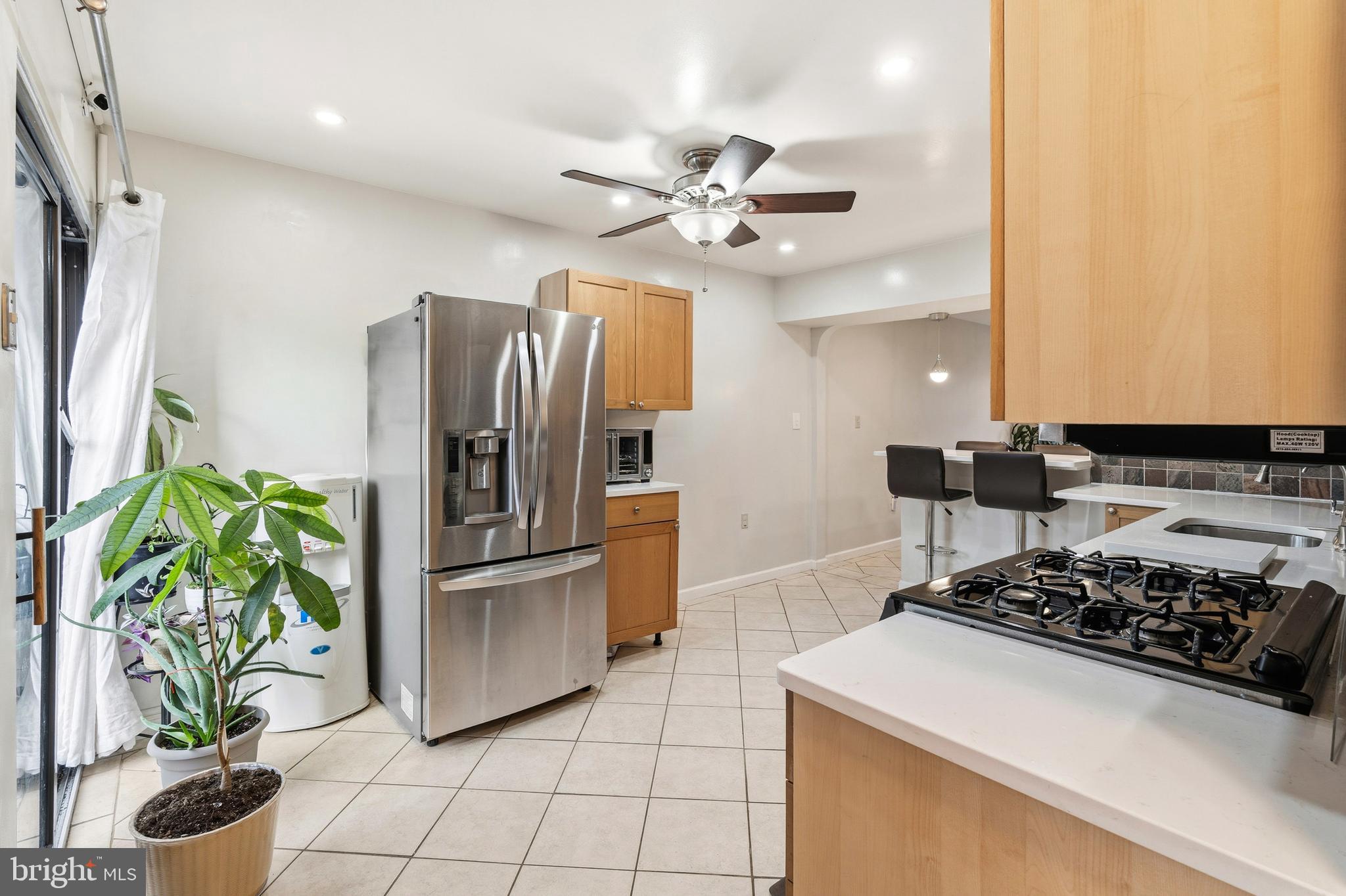 7641 Laytonia Drive Gaithersburg, MD 20877 - Photo 6 of 31 a kitchen with stainless steel appliances granite countertop a refrigerator a stove a sink a counter space and living room view