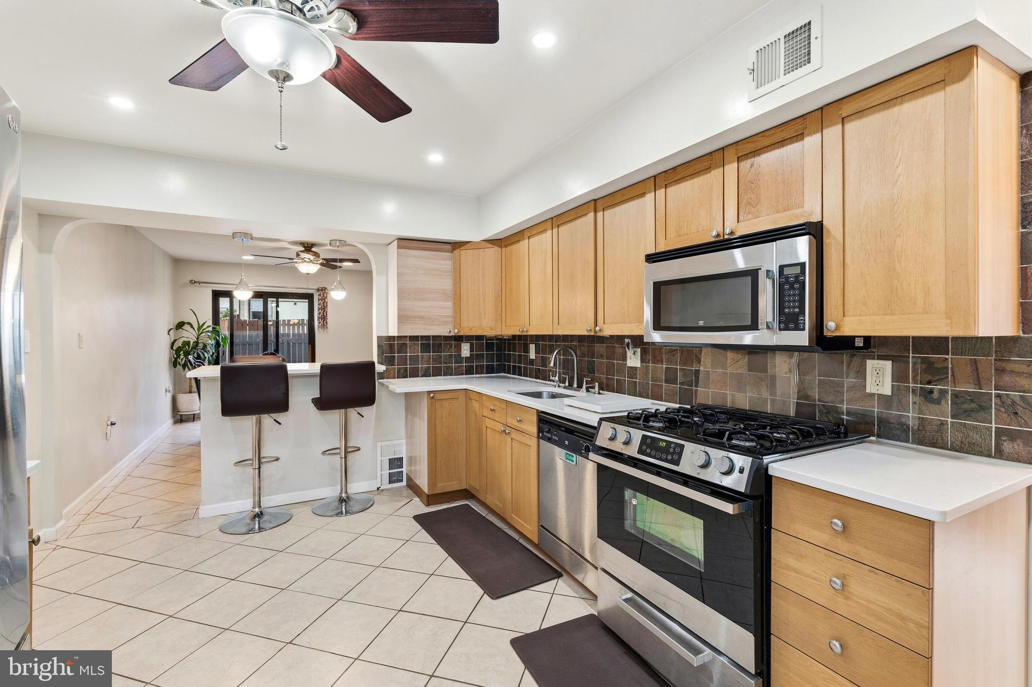 7641 Laytonia Drive Gaithersburg, MD 20877 - Photo 8 of 31 a kitchen with stainless steel appliances granite countertop a stove and cabinets