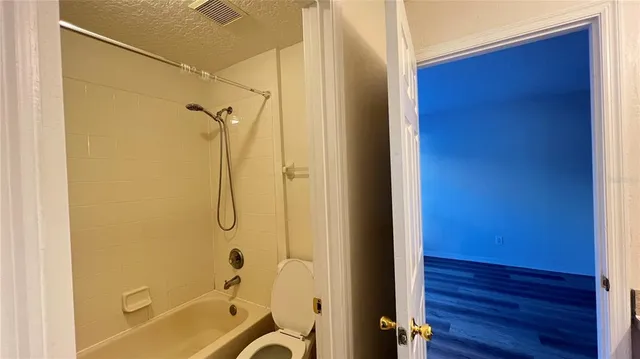 a bathroom with a tub and shower