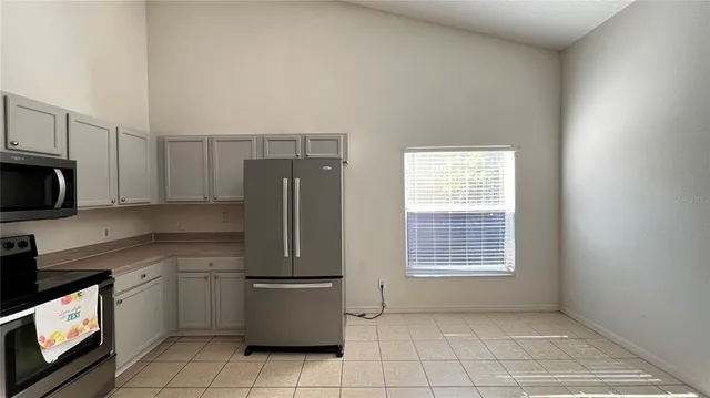 a kitchen with a sink a refrigerator and window