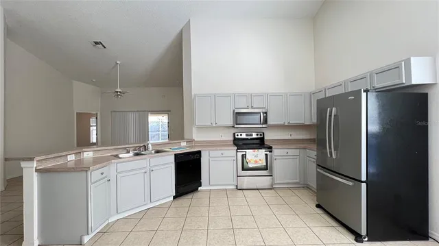 a kitchen with a sink stainless steel appliances and cabinets
