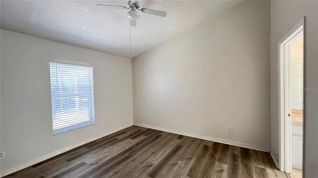 a view of an empty room and a window