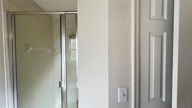 a bathroom with a glass shower door