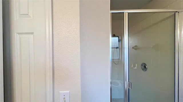 a bathroom with a glass shower door