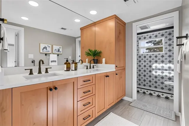 a bathroom with a shower sink and mirror