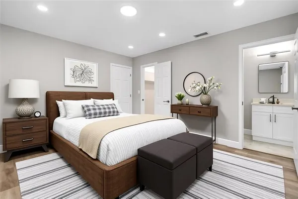 a bed room with a bed and mirror
