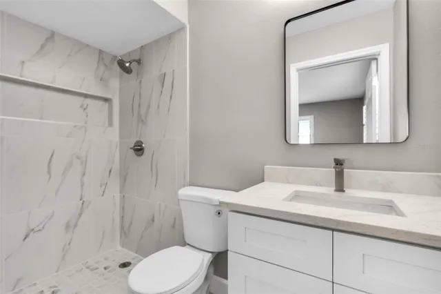 a bathroom with a sink toilet and shower