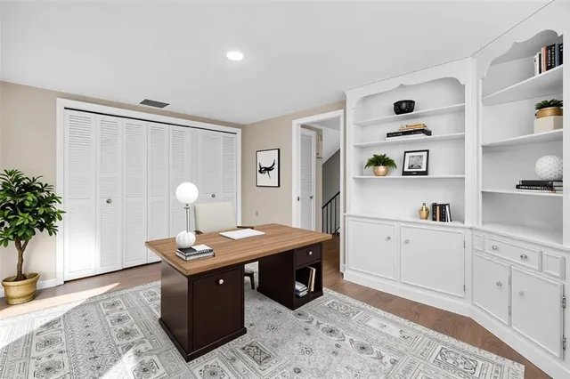 a room with a table chairs and wooden floor