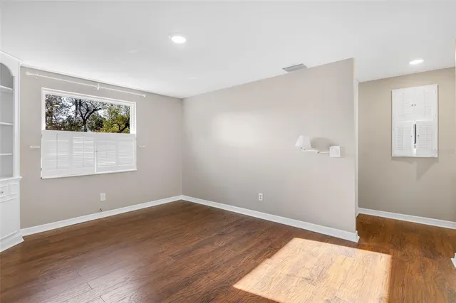 a view of room with window and wooden floor