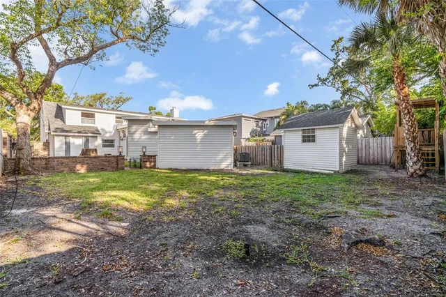 a view of a house with a backyard