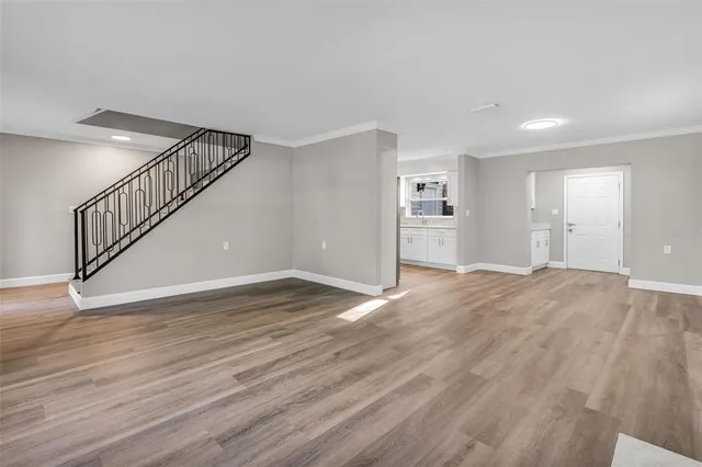 a view of empty room with wooden floor