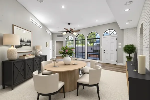 a view of a dining room with furniture and chandelier