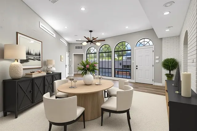 a view of a dining room with furniture and chandelier
