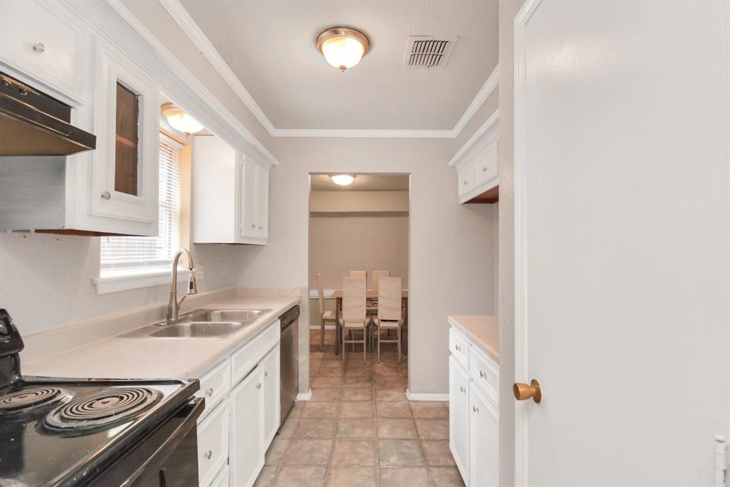 4803 Beechaven Street Houston, TX 77053 - Photo 12 of 30 a kitchen with a sink stove and cabinets