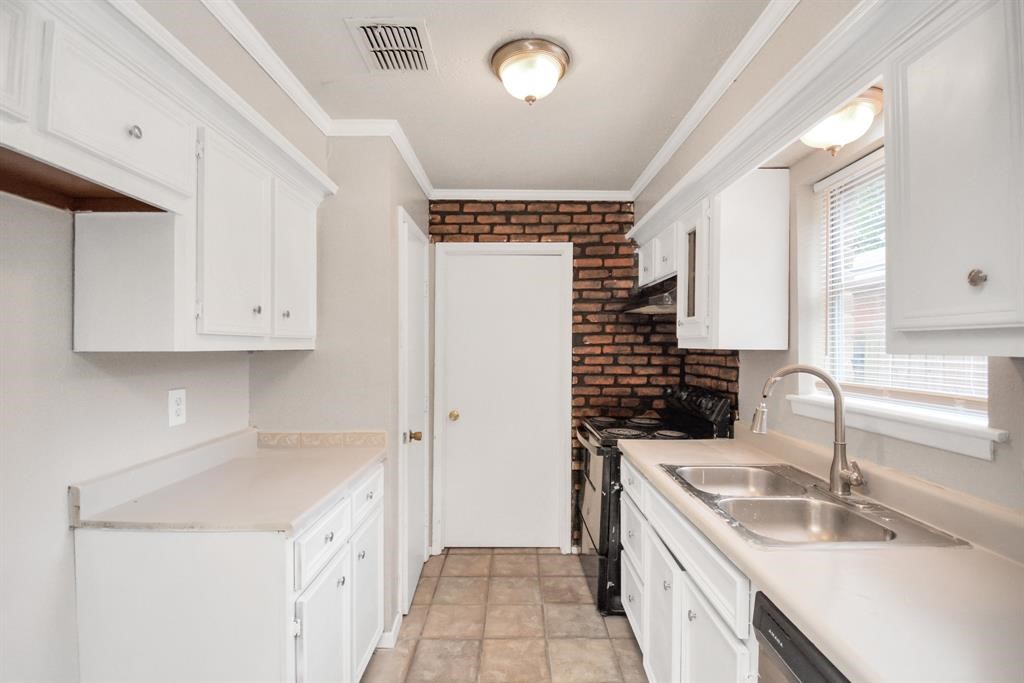 4803 Beechaven Street Houston, TX 77053 - Photo 19 of 30 a kitchen with a sink stove and cabinets