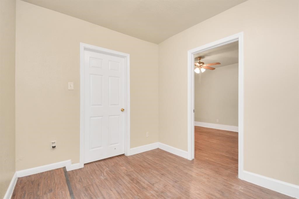 4803 Beechaven Street Houston, TX 77053 - Photo 21 of 30 an empty room with wooden floor and closet