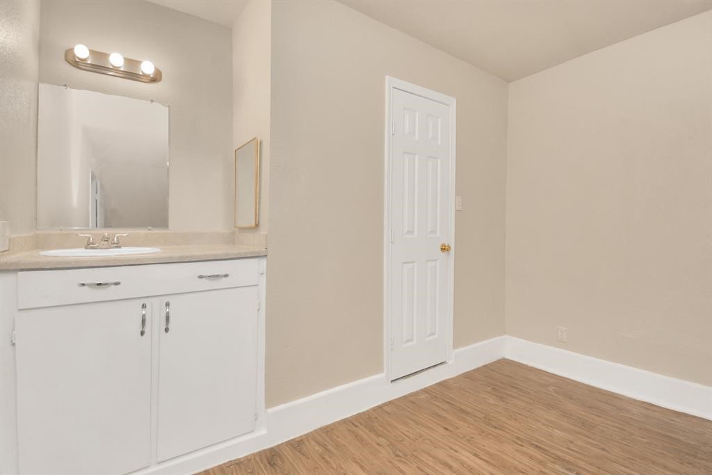 4803 Beechaven Street Houston, TX 77053 - Photo 24 of 30 a bathroom with a sink and a mirror