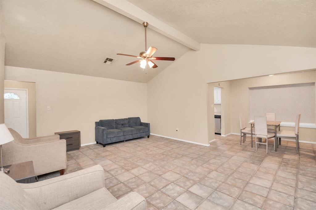 4803 Beechaven Street Houston, TX 77053 - Photo 6 of 30 a living room with couches and kitchen view with wooden floor