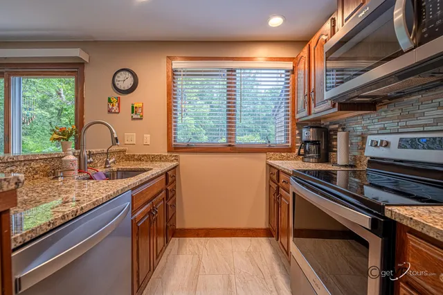 a kitchen with a sink and large windows